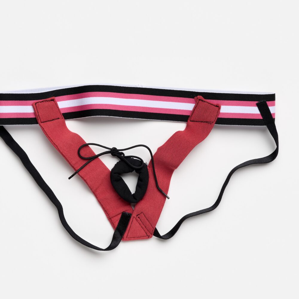 Ein rotes Sportjockstrap mit rosa, weiß und schwarz gestreiftem Bund auf weißem Hintergrund.