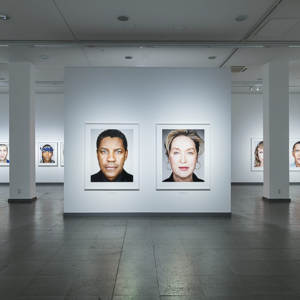 Ausstellungsansicht der Serie Close Up aus der Ausstellung Martin Schoeller mit gleichgestalteten Kopfporträts von Prominenten nebeneinander hängend