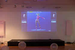 Im NRW-Forum wird an eine Wand ein Computerspiel projeziert und aufblasbare Bälle liegen im Vordergrund